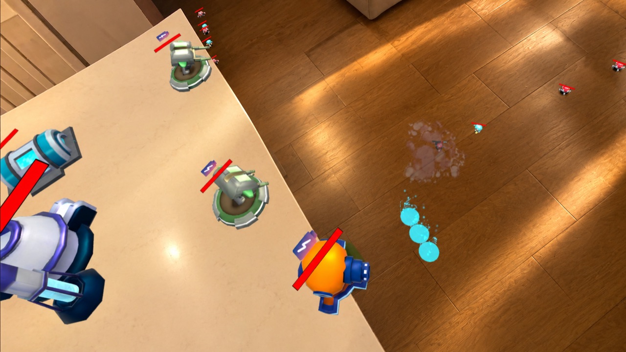 Uno scontro tra robot e torrette tra tavolo e parquet.